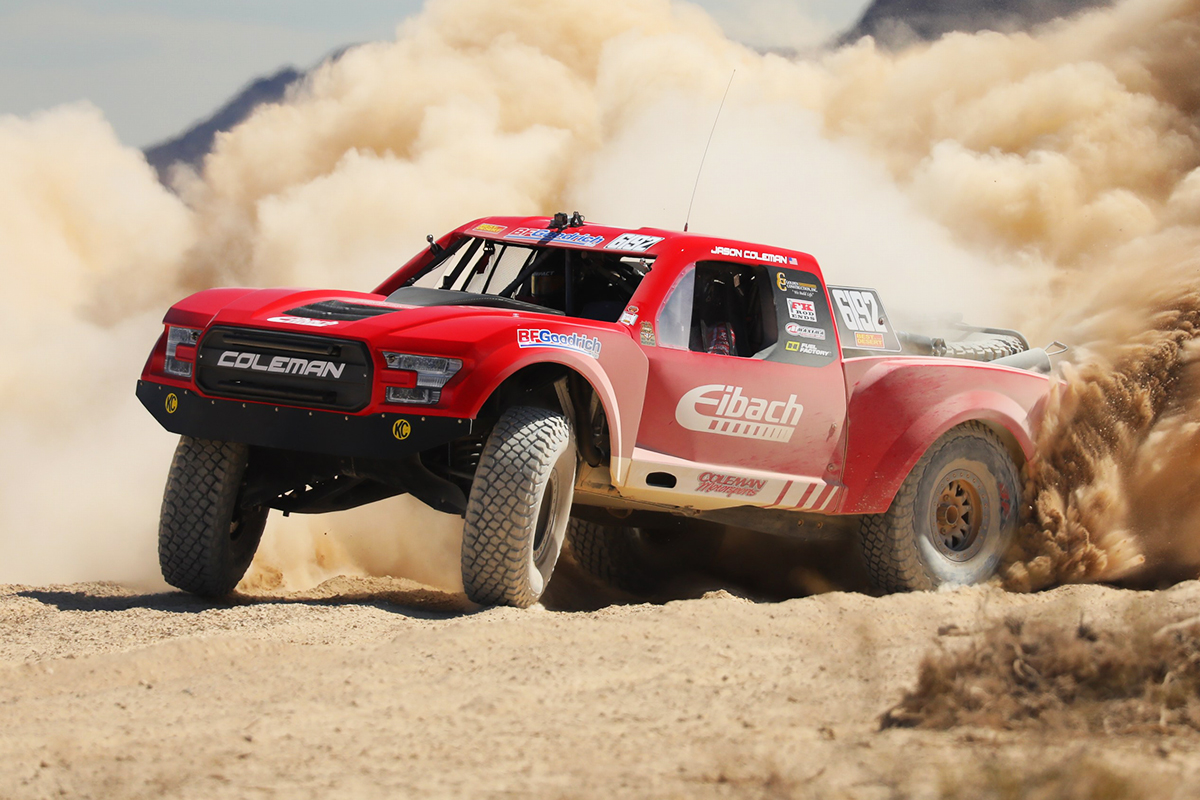 Jason Coleman/Eibach off-road race truck kicking up dust as it powers through the Vegas-to-Reno race course